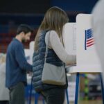 A person casting their vote at a polling station