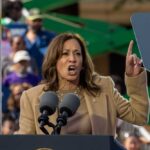 Harris Defends Lemon—Hypocrisy Alarm Blares A woman passionately delivering a speech at an outdoor rally