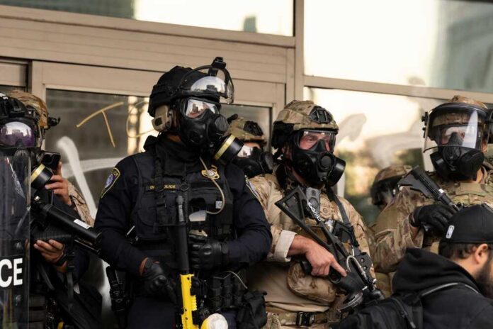 Los,Angeles,,California,,Usa,-,June,10,,2025:,U.s.,Customs Police officers in tactical gear wear gas masks during a crowd control operation