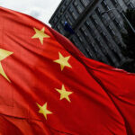 Swarm Tech Targets China’s Invasion Plan Close-up of the Chinese flag waving in the wind
