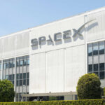 SpaceX headquarters exterior with large logo on white building