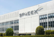 SpaceX headquarters exterior with large logo on white building