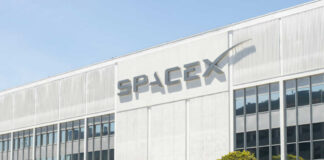 SpaceX headquarters exterior with large logo on white building