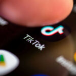 TV Spins TikTok Tragedy Into Panic Finger tapping TikTok app on a smartphone screen