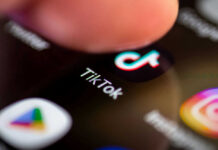 TV Spins TikTok Tragedy Into Panic Finger tapping TikTok app on a smartphone screen