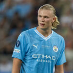 soccer player in light blue jersey on the field