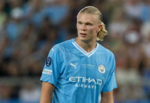 soccer player in light blue jersey on the field