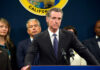 Voters Thundered, Newsom Stalled Person speaks at podium with California seal behind.