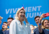 Group taking selfie with smiling woman at event