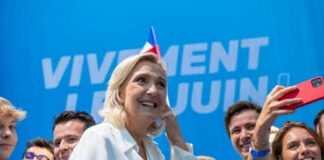 Group taking selfie with smiling woman at event