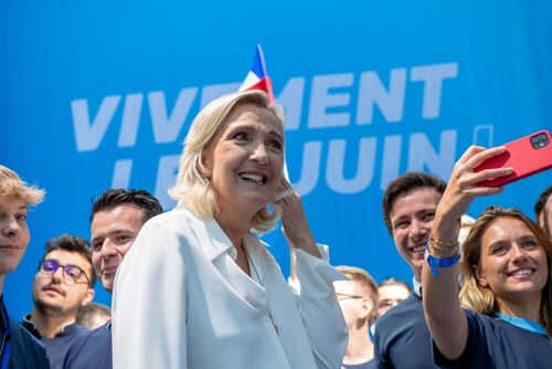 marine-le-pen2368094573 Group taking selfie with smiling woman at event