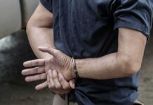 Hotel Pool Horror: Gabbard Name Emerges person in handcuffs with hands behind back