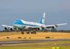 Airplane landing on runway with landing gear extended