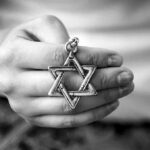 Piers Morgan Stunned—Mace Doubles Down Hand holding a Star of David pendant