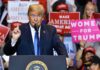 Trump’s Purge Hits Spy Nerve Center politician speaking at rally podium