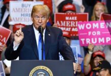 politician speaking at rally podium