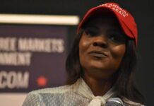 woman in a red cap holding a microphone
