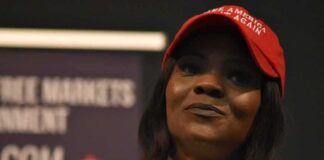 woman in a red cap holding a microphone