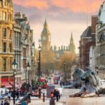 View of London with Big Ben in the background and lion statues in the foreground