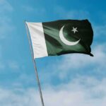 Blackout Turns Kashmir Into A Digital Prison Pakistan flag waving against a blue sky