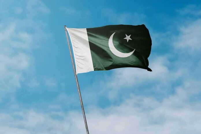shutterstock_1937761651 Pakistan flag waving against a blue sky