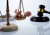 Missouri Shock: Abortion Ban Reversed Scales of justice with a small baby figurine on one side and a gavel in the background