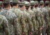 Pentagon Outsourced Judgment—What Could Go Wrong? Soldiers in camouflage uniforms standing in formation from behind