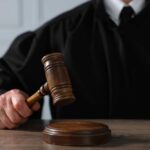 School Massacre Plot Stopped—Then A Plea Deal? A judge holding a gavel above a wooden block