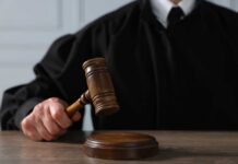 School Massacre Plot Stopped—Then A Plea Deal? A judge holding a gavel above a wooden block