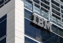 IBM MELTDOWN: Budget Shift Shock Close-up of the IBM logo on a modern corporate building