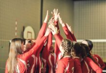 Media Meltdown Over Women’s Sports Ruling Volleyball players celebrating with hands raised together