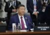 Shanghai Move Threatens U.S. Tech Edge A leader seated at a conference table during an international summit