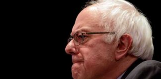 elderly man in profile wearing glasses