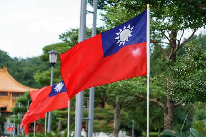 shutterstock_525450697 Taiwan flag waving on a pole in a green park