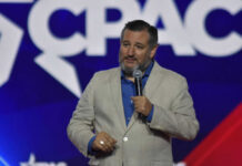 100% Vote? Trump’s Wild Cruz Pitch Man speaking at a conference with microphone