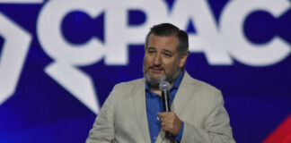 Man speaking at a conference with microphone