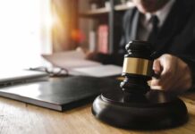 Shocking Leniency In Baby Death Case Judge's gavel on desk with person reading documents in background