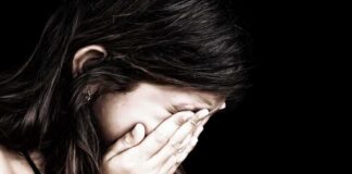 Child covering face with hands