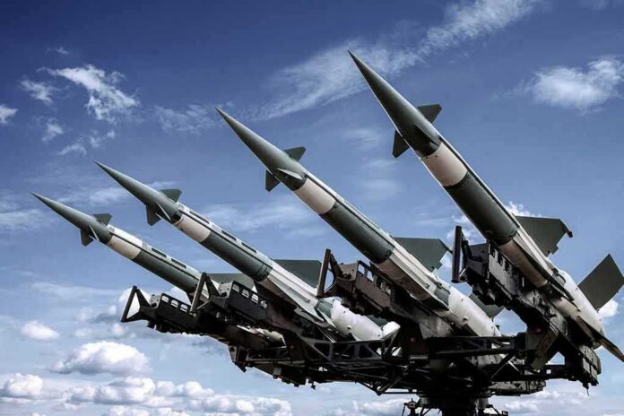 Surface-to-air missiles mounted on a launcher against a blue sky