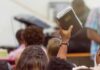 Hand holding a Bible in a crowded church service