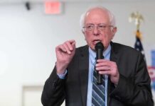 Elderly man speaking into a microphone