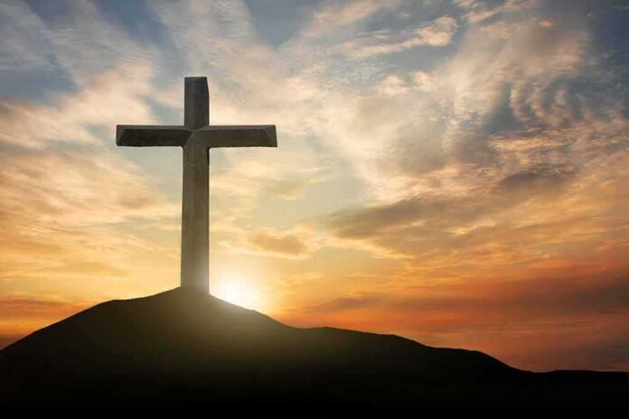 shutterstock_1506152891 Cross on hill at sunset