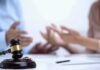 One-Sided Divorce On The Chopping Block Judge's gavel with wedding rings as two people argue in background