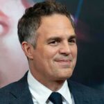 A-List Blast Triggers Antisemitism Uproar man in a suit smiling at a red carpet event