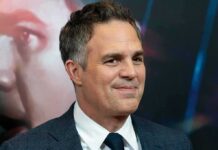 A-List Blast Triggers Antisemitism Uproar man in a suit smiling at a red carpet event