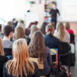 Hate Invades Classrooms — ADL Sounds Alarm Students seated in a classroom listening to a presentation