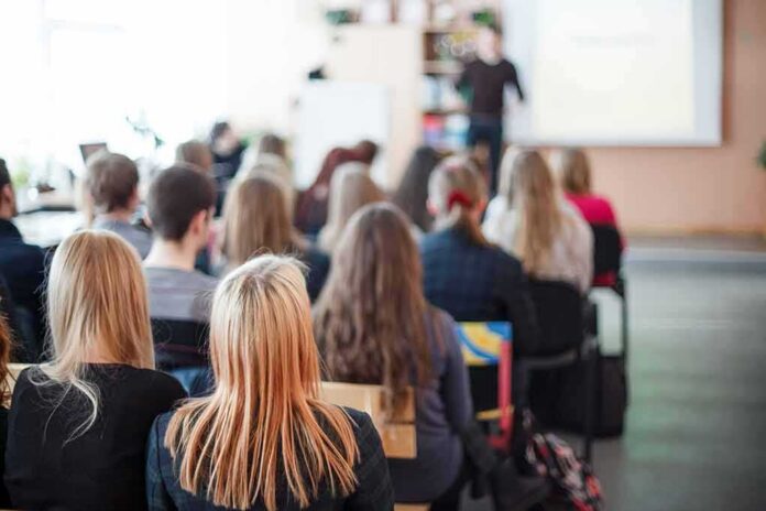 shutterstock_174265457 Students seated in a classroom listening to a presentation