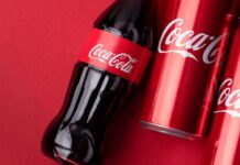 Coca-Cola Tool Glitch — Or Ideology Leak? Coca-Cola bottle and cans on red background
