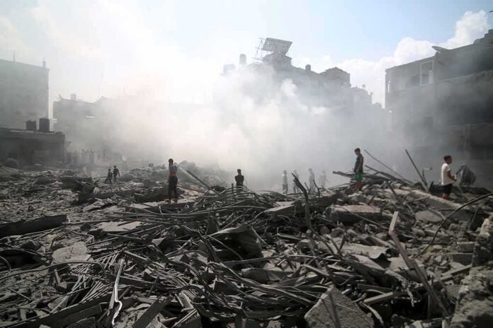 shutterstock_2374212975 People walking through smoke-filled urban rubble