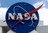 Chasing Darkness, NASA Finds Something Wild NASA logo on a large blue circular sign